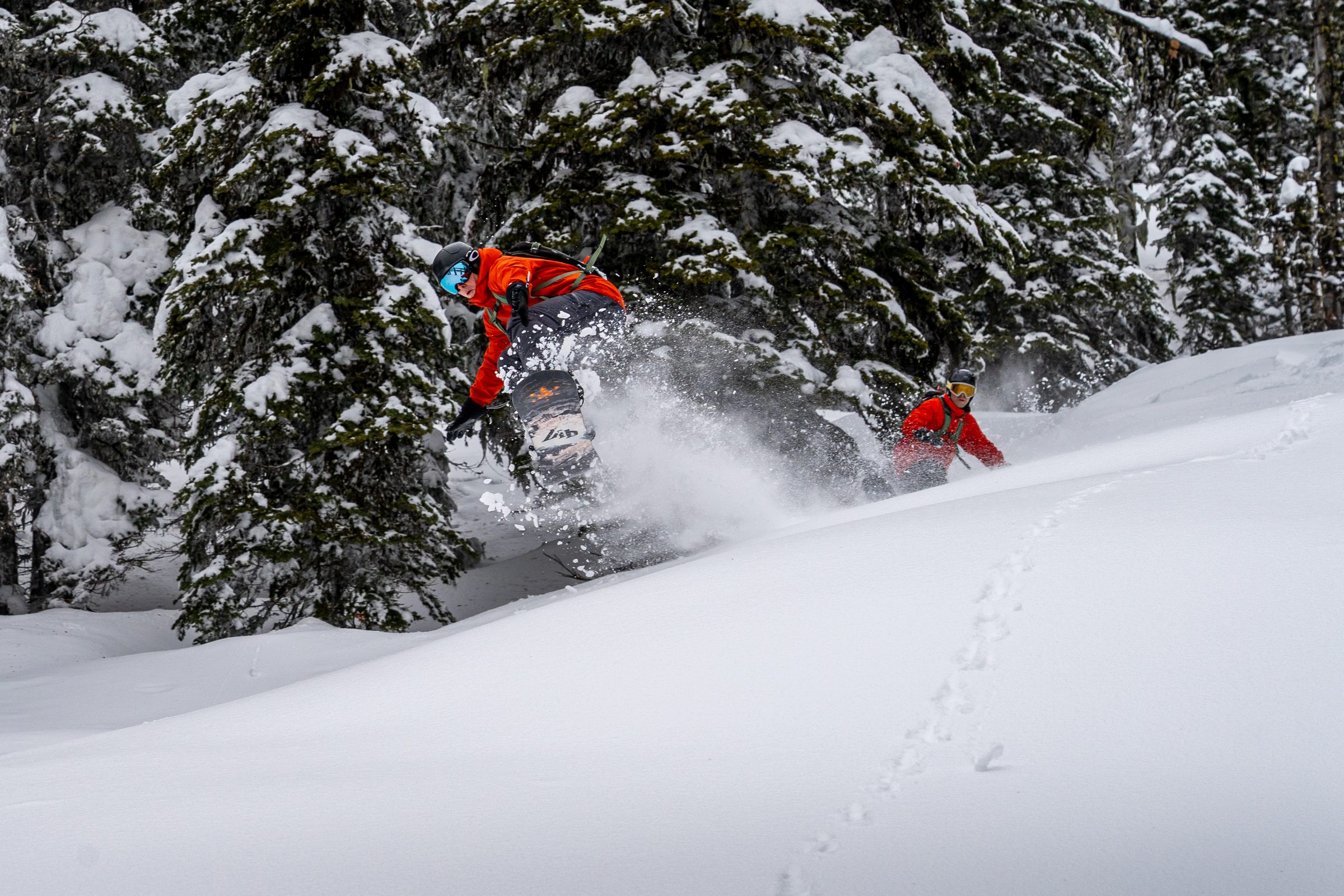 Dan Martell and Roddy Awad riding powder through the trees at Baldface